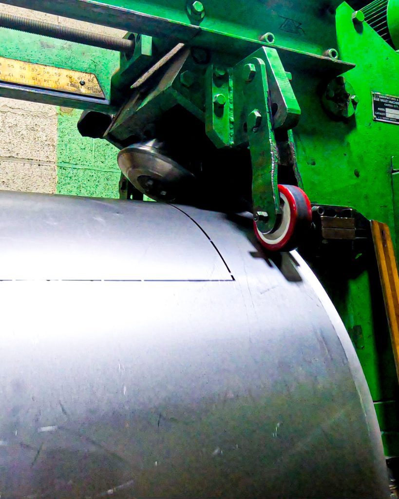 Large rolled and welded cylinder being flanged